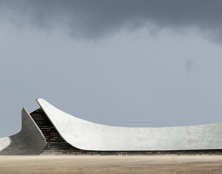 A pavilion with a sweeping concrete roof rising from a flat horizon under stormy light.